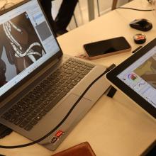 A young person using a graphic tablet for drawing.