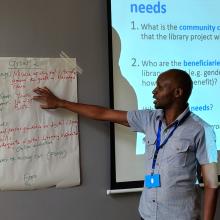 Raymond Chepkwony of Kenya National Library Service (KNLS) gives feedback from newsprint during group discussion.