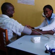 A health worker treating a patient at a clinic.