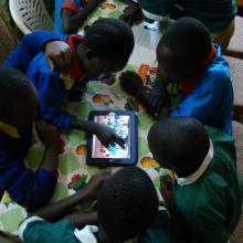 Children use tablet computers in the library. 