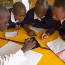 Children use tablet computers to access educational content linked to the school curriculum in Kibera Public Library.