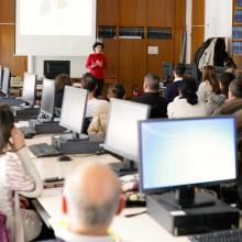 Journal editors working on computers during an EIFL-KOBSON workshop, while listening to an address by EIFL OA country coordinator in Serbia, Milica Ševkušić.