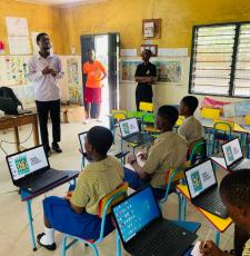 Ghanaian schoolchildren learning to use computers in a school classroom. 