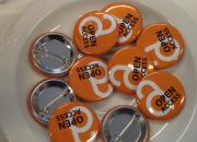 a group of open access lapel buttons.