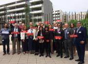 Group of delegates to WIPO holding placards with the names of their organisations.