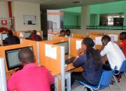 Students learning on computers in a library.