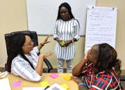 Three public librarians discuss project management during training in Windhoek in February 2019.