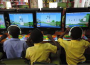 Three children using computers with maths software to practice their maths.