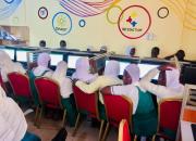 A group of schoolgirls in a classroom with computers.