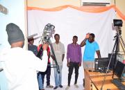 A group of young photographers try out the cameras and other equipment in the library.