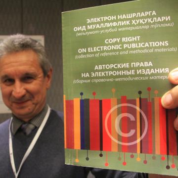 Photo of EIFL's country coordinator in Uzbekistan proudly holds up a new booklet ‘Copyright on Electronic Publications' translated from EIFL resources. The booklet is available in Russian and Uzbek.