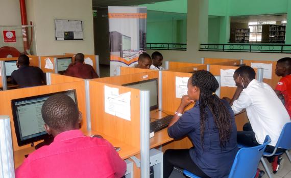 Students learning on computers in a library.