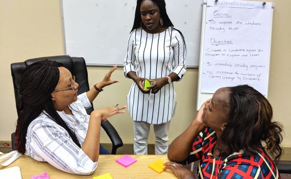 Three public librarians discuss project management during training in Windhoek in February 2019.