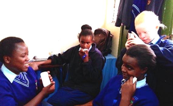 Children using DAISY readers to access audio textbooks. Nairobi Area Library's service increases blind and visually impaired children's access to knowledge. Visually impaired schoolchildren using DAISY (digital audio) devices in Nairobi Area Library.
